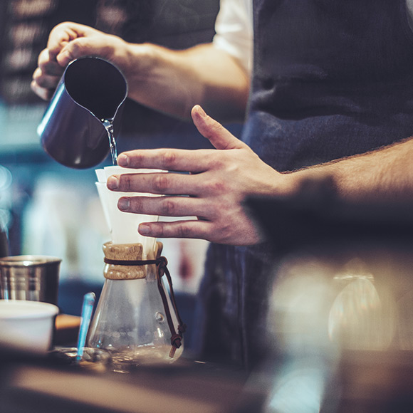 Barista preparing filter coffee to depict commercial combined insurance by Find Insurance NI