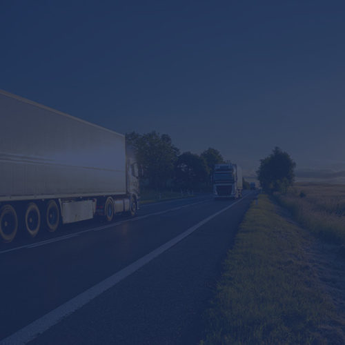 Lorries driving on a road to depict fleet insurance by Find Insurance NI