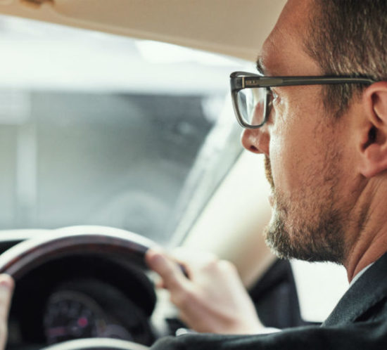 Man driving with glasses for Find Insurance NI blog