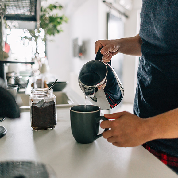 Man pouring coffee to depict Household insurance by Find Insurance NI