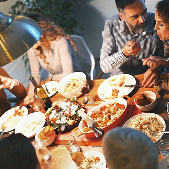 Family eating around table to depict Household insurance by Find Insurance NI