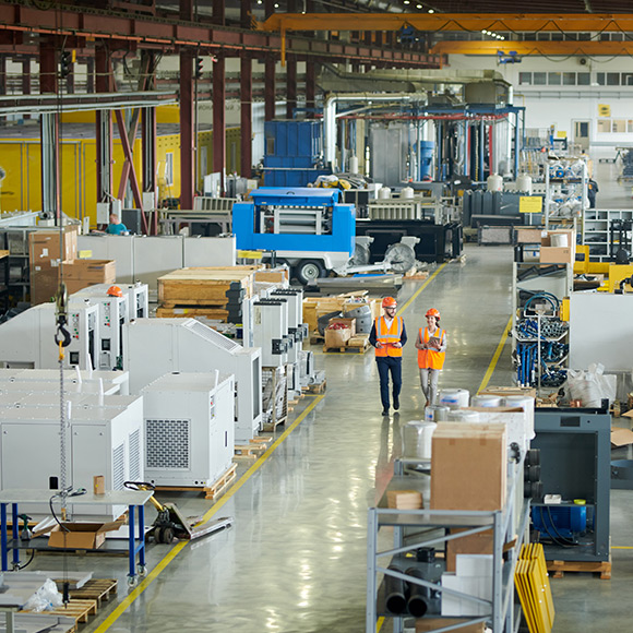 Walking through manufacturing plant to depict manufacturing insurance by Find Insurance NI