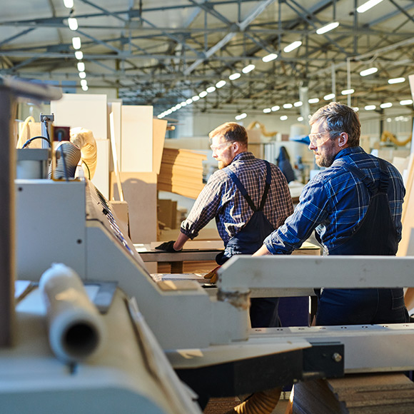 Working with manufacturing equipment to depict manufacturing insurance by Find Insurance NI
