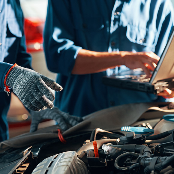 Conducting MOT on car to depict motor trade insurance by Find Insurance NI