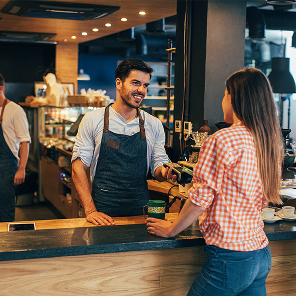 Woman buying drink from coffee house to depict shops and offices insurance by Find Insurance NI