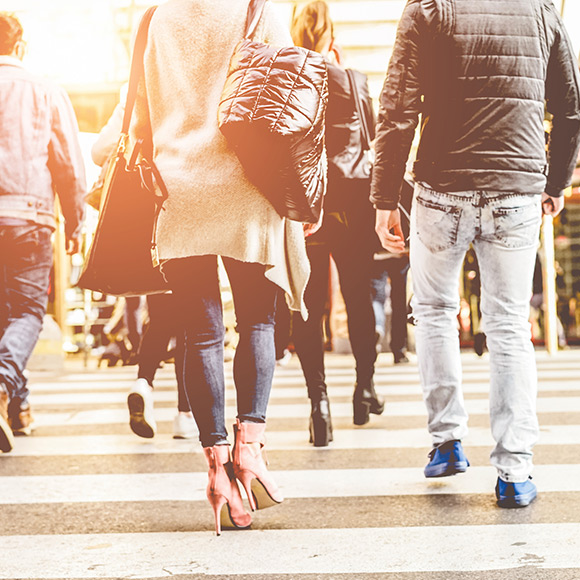 Shoppers walking down high street to depict shops and offices insurance by Find Insurance NI